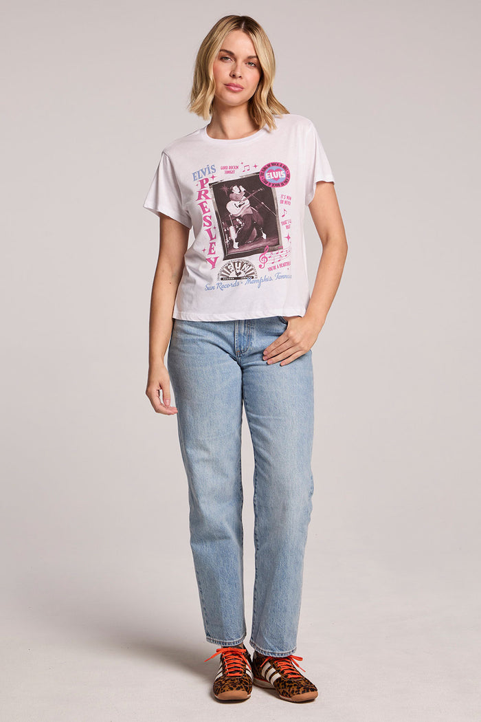 Front view of a woman wearing the Chaser  Sun Records Rock & Roll King Collage Tee and sneakers on a neutral background