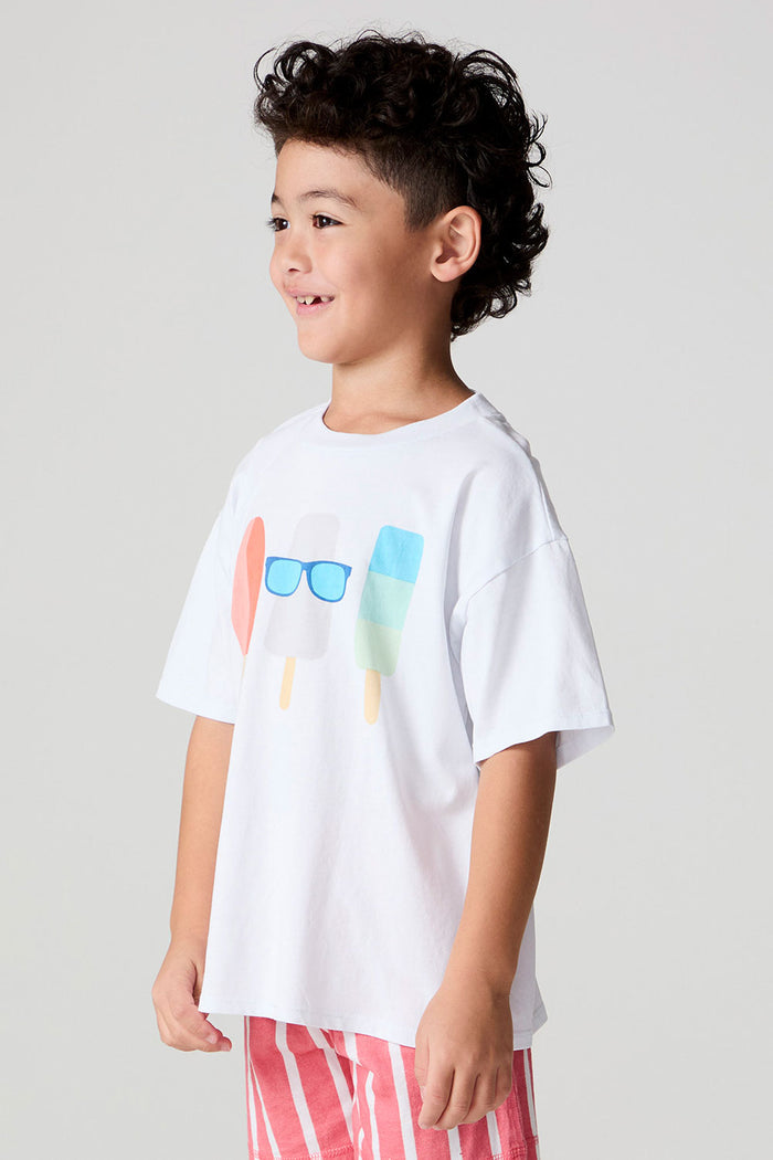 Side angle view of a boy wearing the Chaser Sunglass Pop Tee  on a neutral background