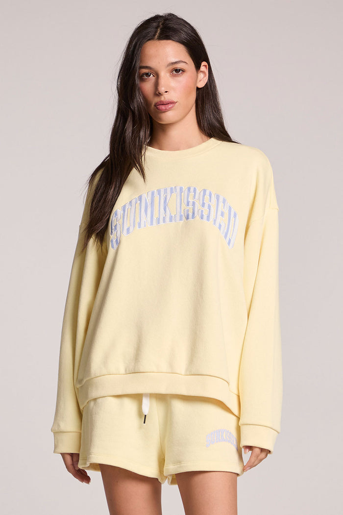 Front  view of a woman wearing the Chaser  Sunkissed Long Sleeve and shorts on a neutral background