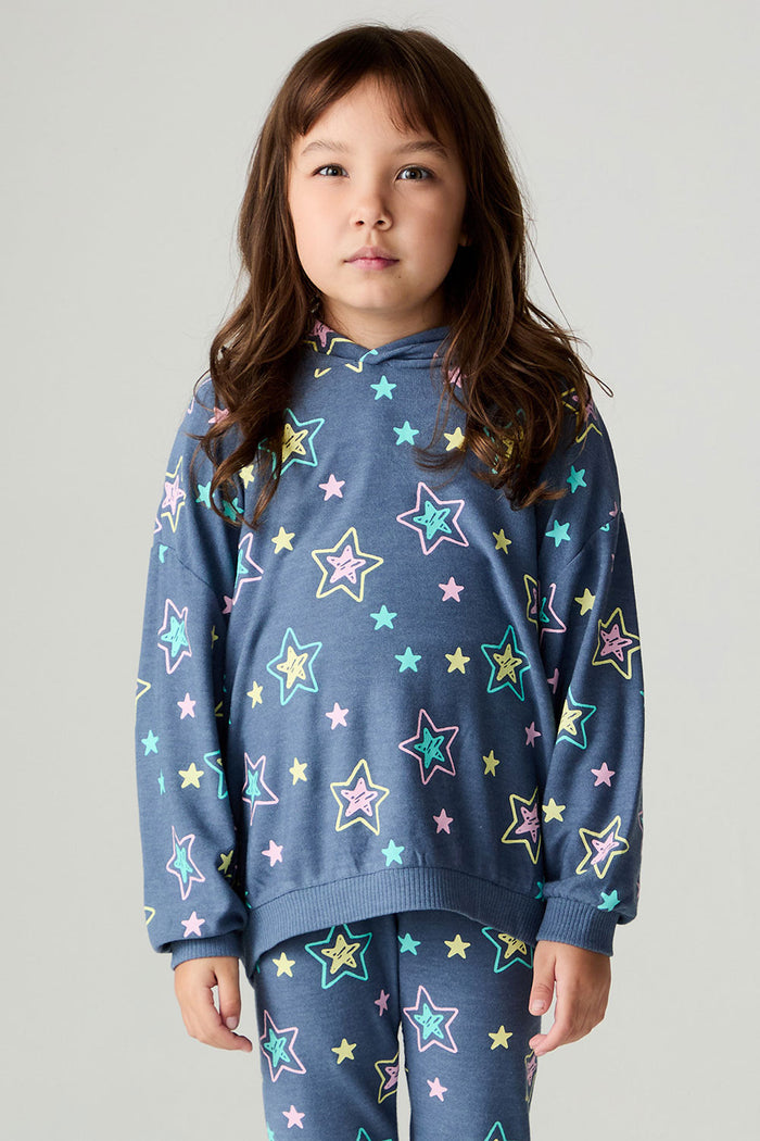 Front view of a girl wearing the Chaser Super Star Girls Zip Up on a neutral background with matching star pants
