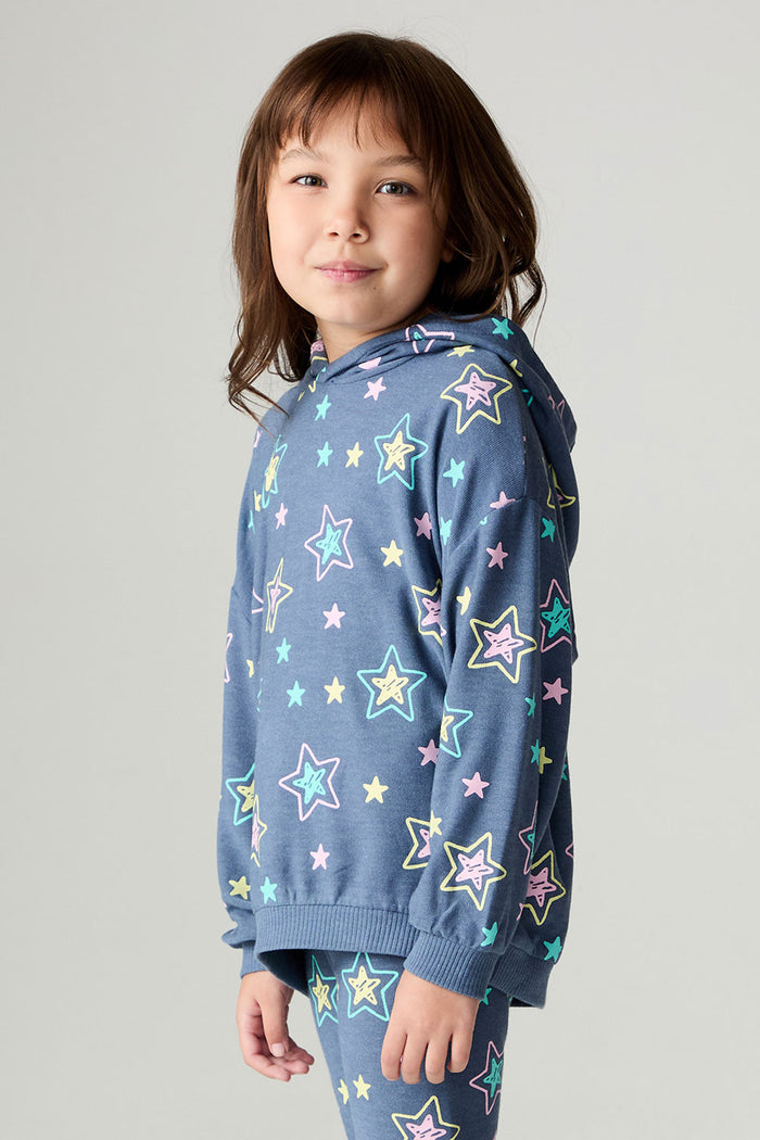 Side angle view of a girl wearing the Chaser Super Star Girls Zip Up on a neutral background with pants