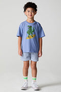 Full body front view of a boy wearing the Chaser Surfin T-Rex Tee on a neutral background