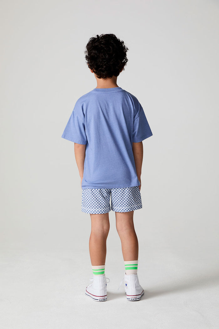 Full body back view of a boy wearing the Chaser Surfin T-Rex Tee on a neutral background