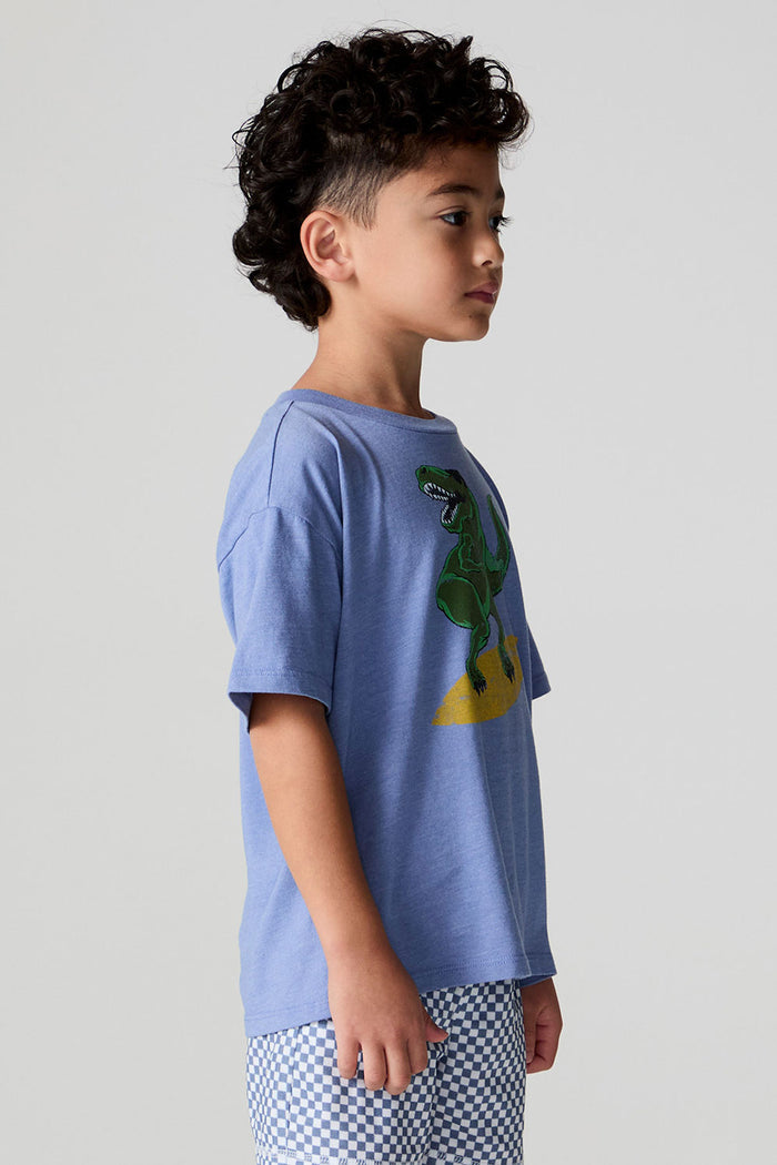 Side angle view of a boy wearing the Chaser Surfin T-Rex Tee on a neutral background