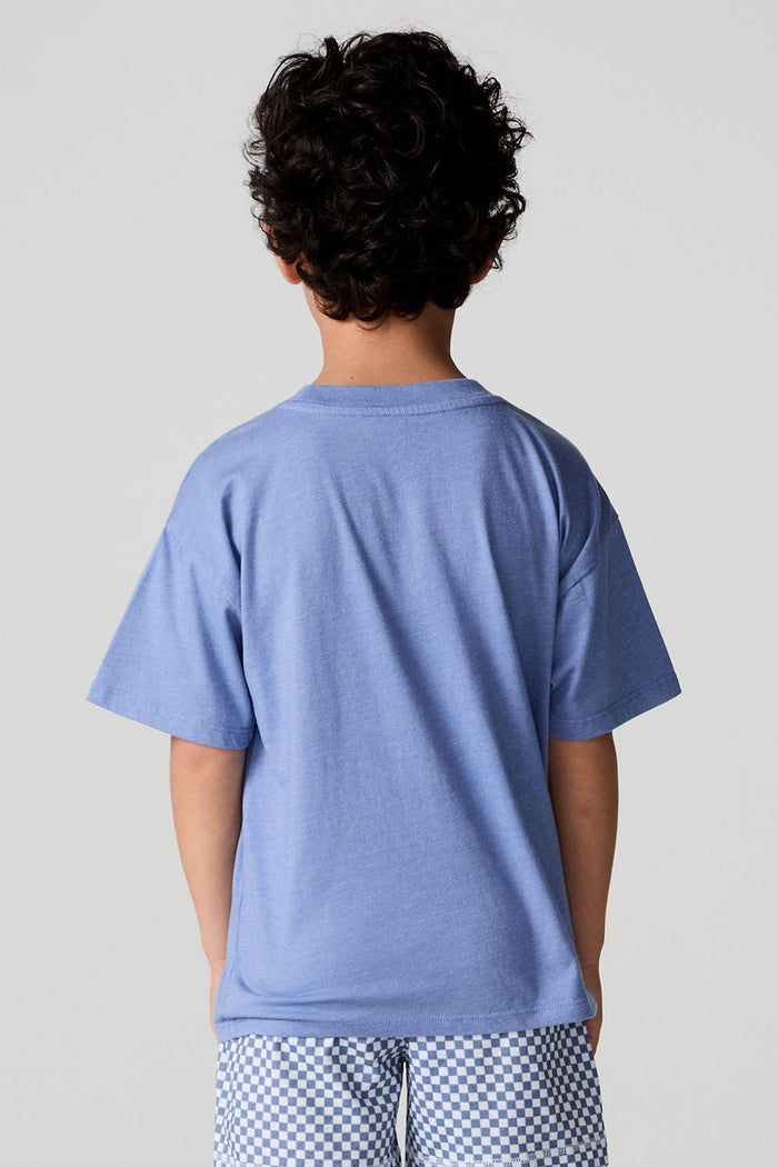 Back view of a boy wearing the Chaser Surfin T-Rex Tee on a neutral background