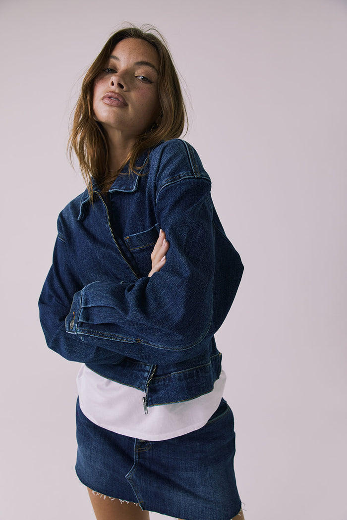 Angled front view of the Chaser Sutton Indigo Wash Jacket highlighting the structured denim fabric and relaxed fit