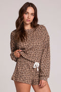 Front view of a woman wearing the Chaser Suzzans Leopard Sweatshirt on a neutral background