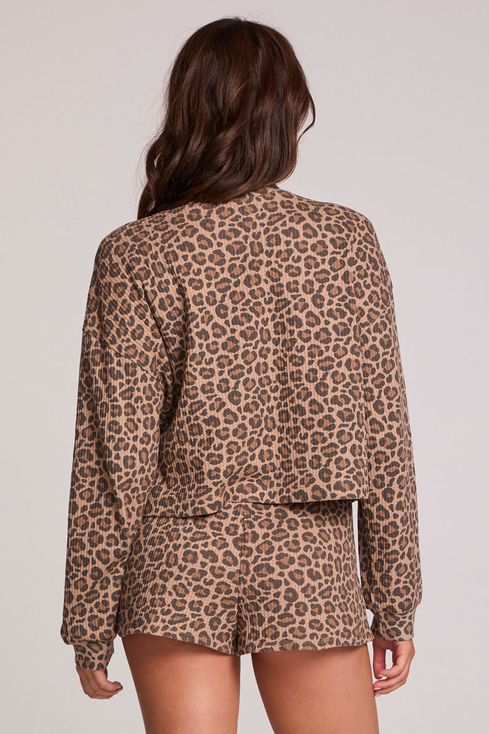 Back view of a woman wearing the Chaser Suzzans Leopard Sweatshirt on a neutral background with matching shorts