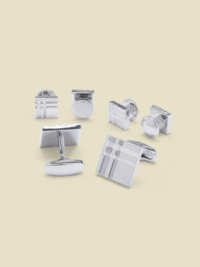 Silver etched square cufflinks and studs set on beige background