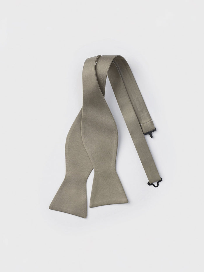 Taupe satin self-tie butterfly bow tie, untied and laid flat on a grey background