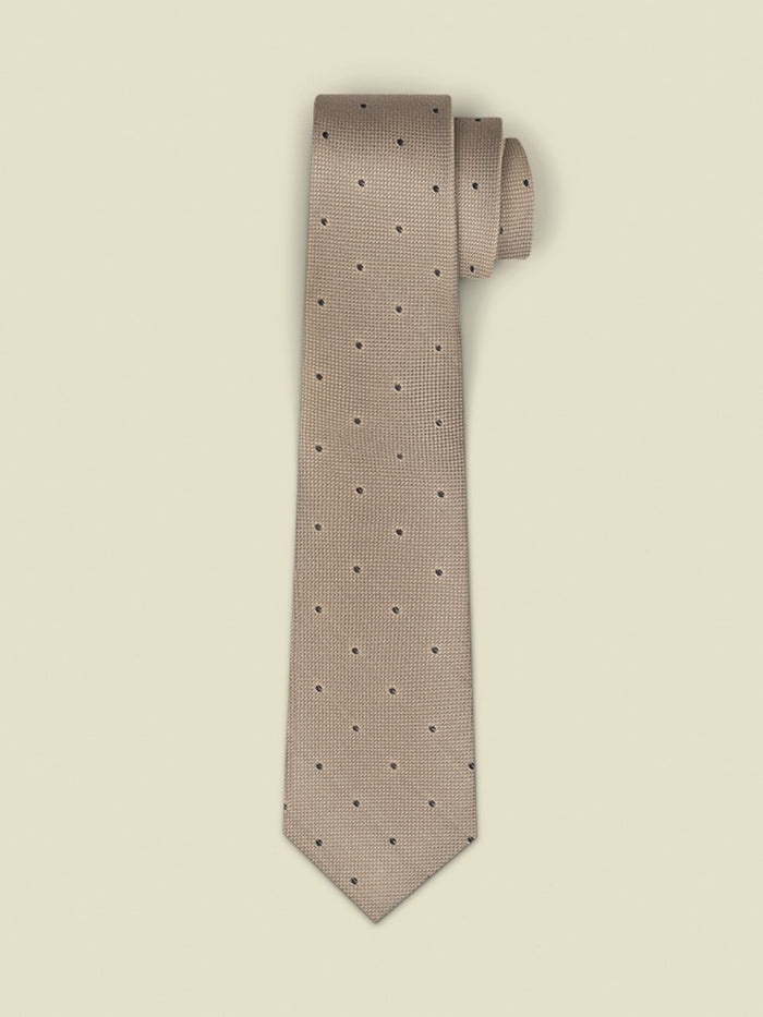 Taupe silk tie with navy dot pattern, rolled, on cream background
