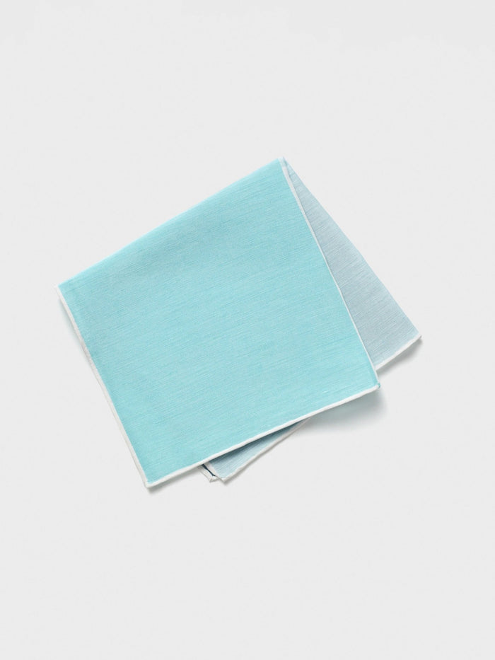 Teal cotton pocket square with white edge, folded on a white background