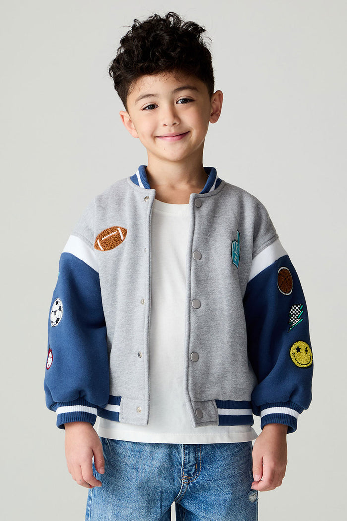 Front view of a boy wearing the Chaser Team Spirit Boys Jacket on a neutral background with jeans and white shirt