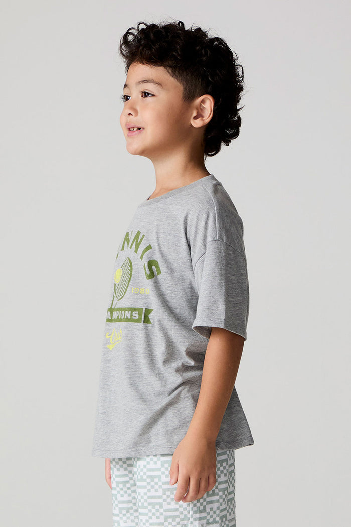 Side angle view of a boy wearing the Chaser Tennis Club Tee on a neutral background