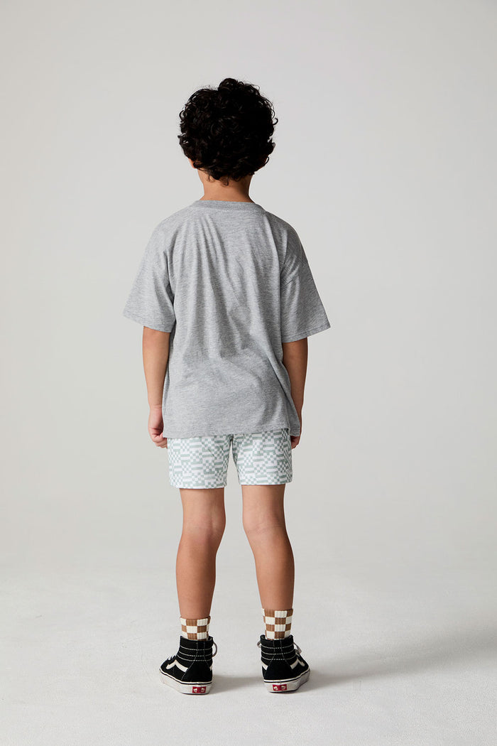 Full body back view of a boy wearing the Chaser Tennis Club Tee on a neutral background