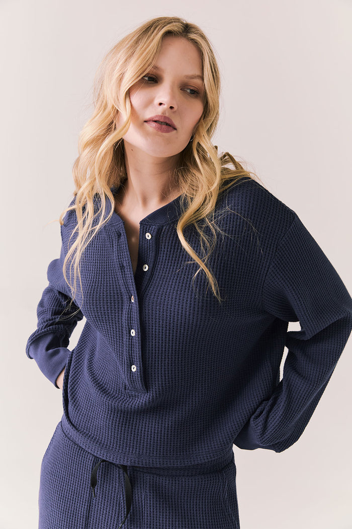 Front view of Thayne cropped thermal henley top in Midnight Blue with 3/4 button placket and ribbed texture against a plain background