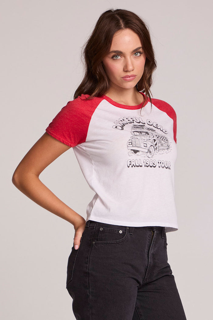 Side angle view of a woman wearing the The Grateful Dead Fall 1989 Tour Tee on a neutral background with hand on one hip