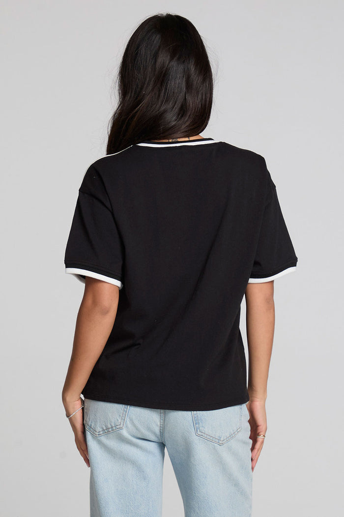 Back view of a woman wearing the Chaser The Grateful Dead Winterland Area Tee on a neutral background with jeans