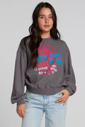Front view of a woman wearing the Chaser The Paris Punk Graphic Sweatshirt on a neutral background