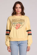 Front view of a woman wearing the Chaser  The Rolling Stones 1978 Long Sleeve Tee and jeans on a neutral background with arms lowered