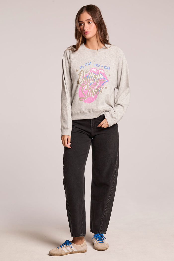 Front view of a woman wearing the Chaser  The Rolling Stones It's Only Rock & Roll Tee and sneakers on a neutral background
