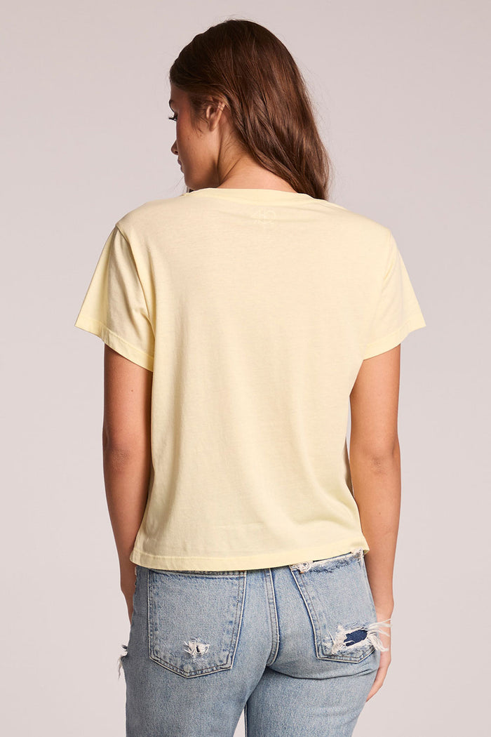 Back view of a woman wearing the Chaser  Rolling Stones Logo Magazine Mix Tee on a neutral background