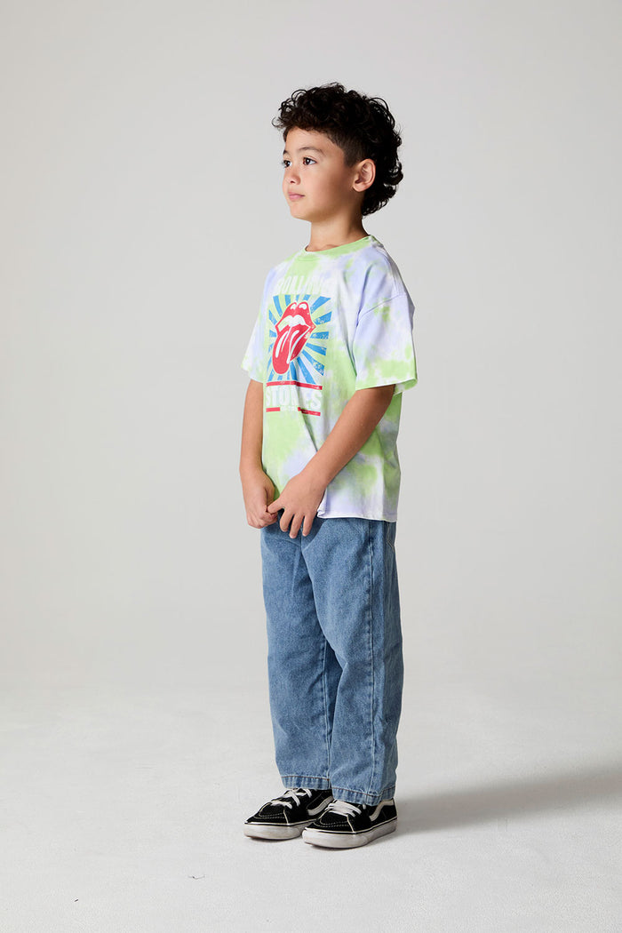 Full body side angle view of a boy wearing the Chaser The Rolling Stones Tie Dye Tee on a neutral background