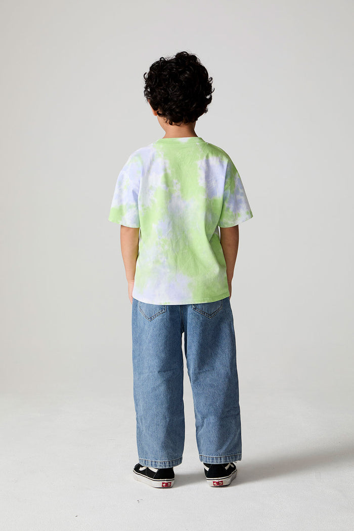 Full body back view of a boy wearing the Chaser The Rolling Stones Tie Dye Tee on a neutral background