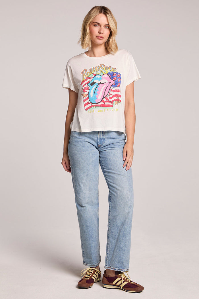 Full body ront view of a woman wearing the Chaser The Rolling Stones USA Tour 89 Tee and sneakers on a neutral background
