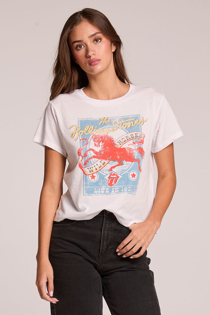 Front view of a woman wearing the Chaser   The Rolling Stones Wild Horses Tee and black jeans on a neutral background