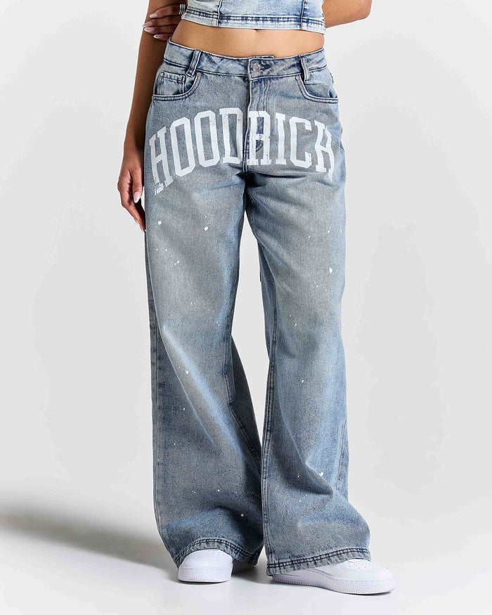 Person wearing light blue jeans with 'HOODRICH' text on a white background