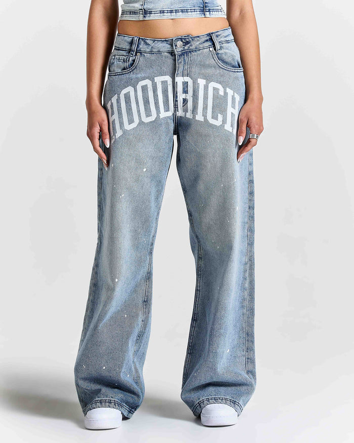 Person wearing blue jeans with 'Hoodrich' branding on a white background