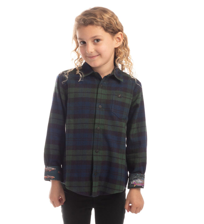 Smiling child in Pladra Toddler Cubs Flannel Shirt—Bolinas Blue—stands against a white background.