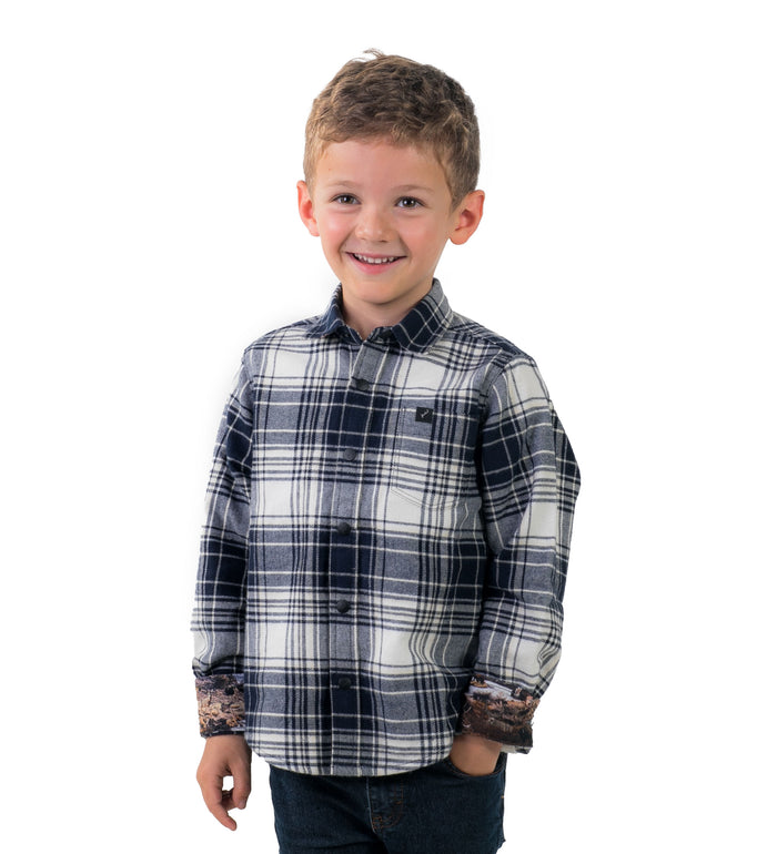 Toddler Cubs Flannel Shirt in Butte Blue, a blue and white plaid with rolled cuffs, worn with dark jeans by a young boy.