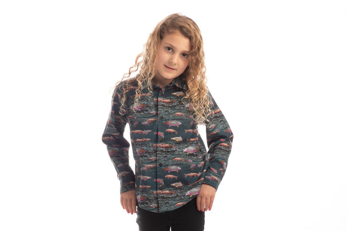 Toddler with long curly hair wears a Pladra Toddler Cubs Printed Shirt - Trout, standing against a white background.