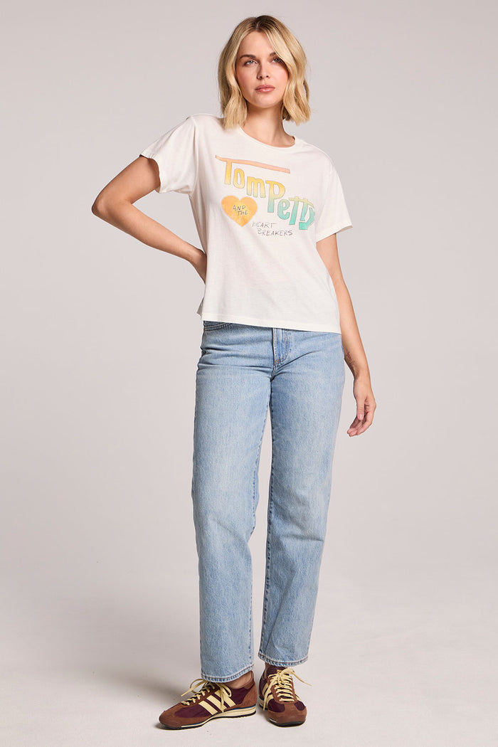 Front full body view of a woman wearing the Chaser Tom Petty Live at the Whiskey 77 band Tee and shoes on a neutral background