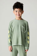 Front view of a boy wearing the Chaser Touchdown Boys Tee on a neutral background with matching long-sleeve shirt