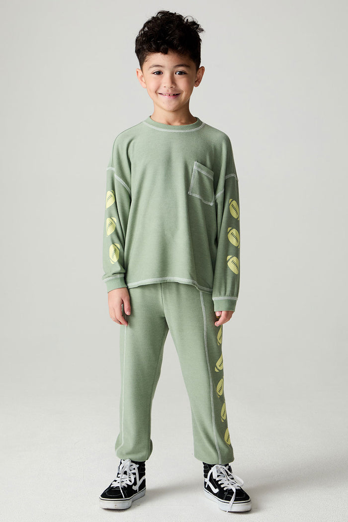 Full body front view of a boy wearing the Chaser Touchdown Pants Boys Jogger on a neutral background and matching long-sleeve shirt
