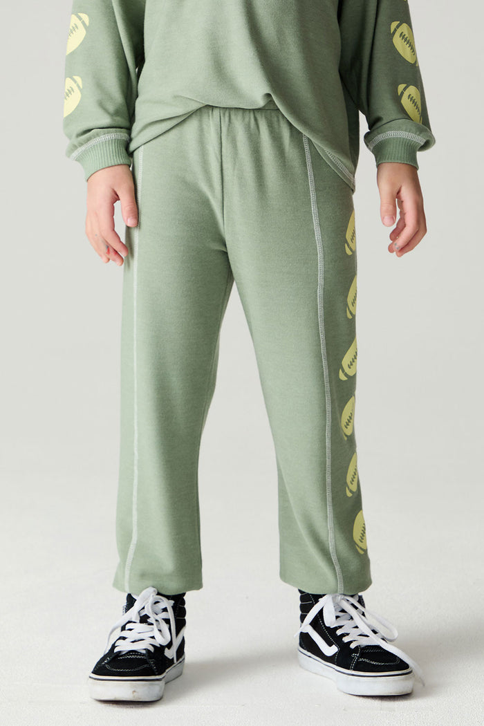 Front view of a boy wearing the Chaser Touchdown Pants Boys Jogger on a neutral background and long-sleeve shirt