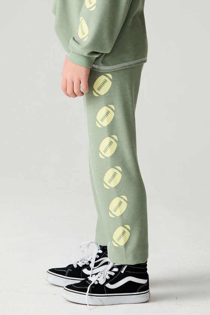 Side view of a boy wearing the Chaser Touchdown Pants Boys Jogger on a neutral background and shirt