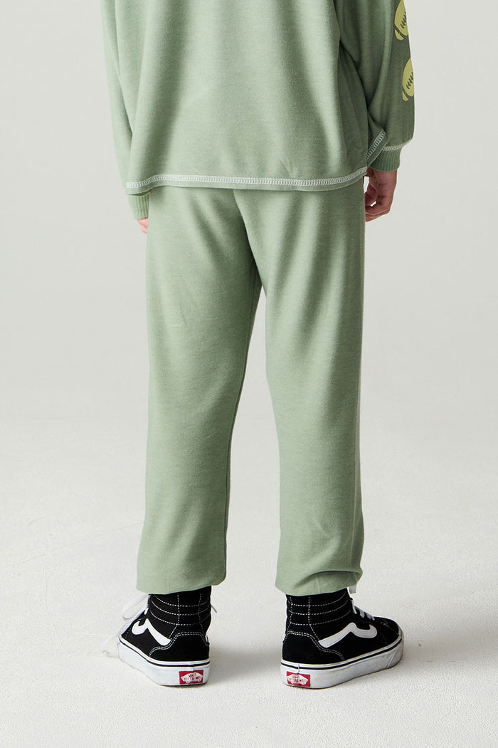 Back view of a boy wearing the Chaser Touchdown Pants Boys Jogger on a neutral background