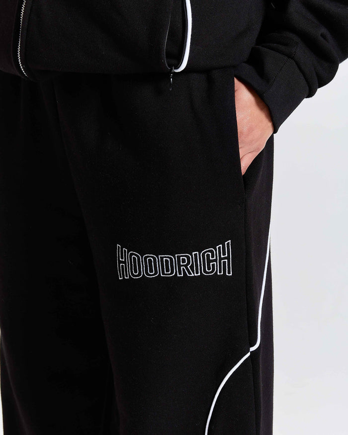 Black tracksuit with 'Hoodrich' branding on a light gray background