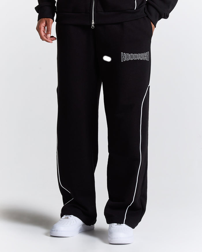 Black tracksuit with white piping on a plain background