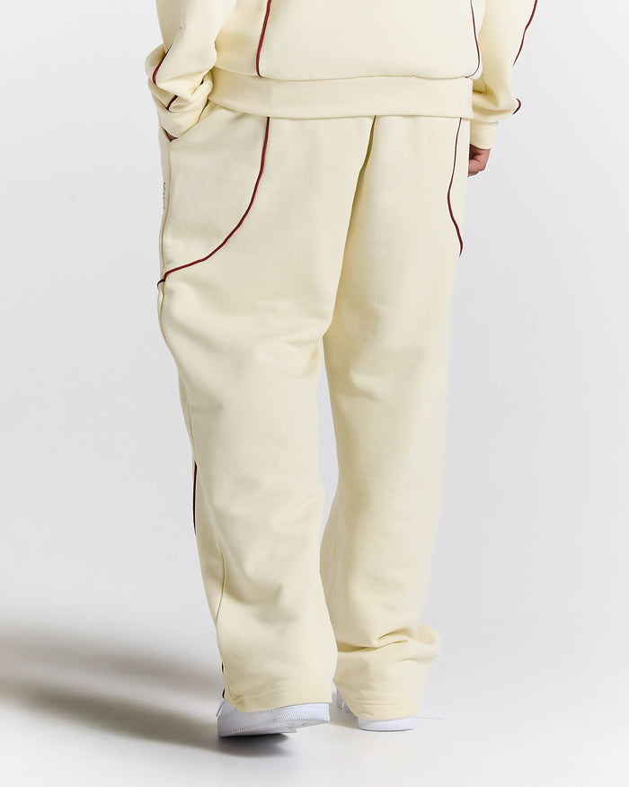 Beige tracksuit with red piping on a white background