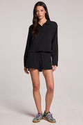 Front view of a woman wearing the Chaser True Black Atlantis Shorts set on a neutral background