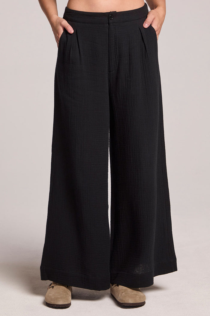 Front view of a woman wearing the Chaser True Black Campaniaa Trousers on a neutral background