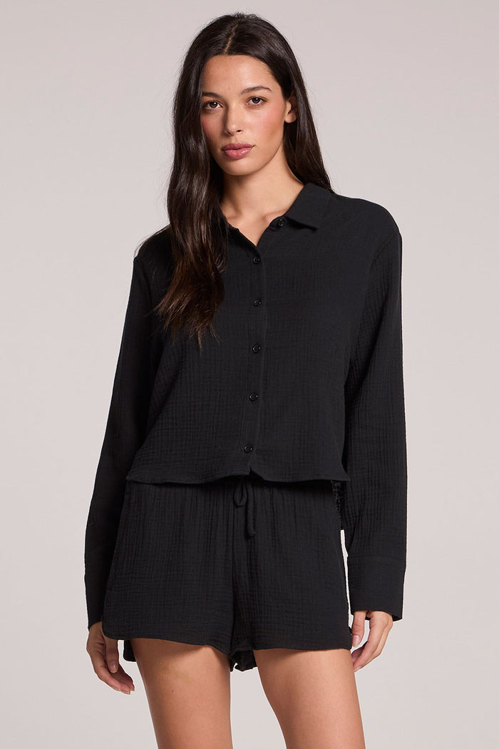 Front view of a woman wearing the Chaser Paso long sleeve set in true black on a neutral background