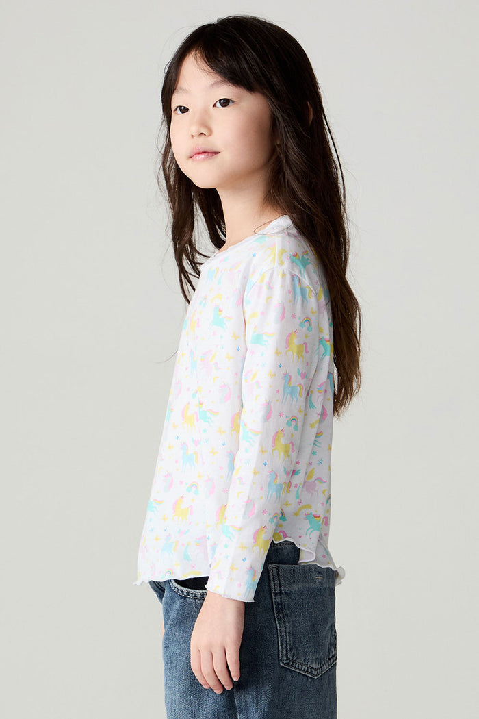 Side view of a girl wearing the Chaser Unicorn Friends Girls Tee on a neutral background with bluejeans