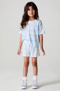 Full body front view of a girl wearing the Chaser  Unicorn Lightning Skort on a neutral background