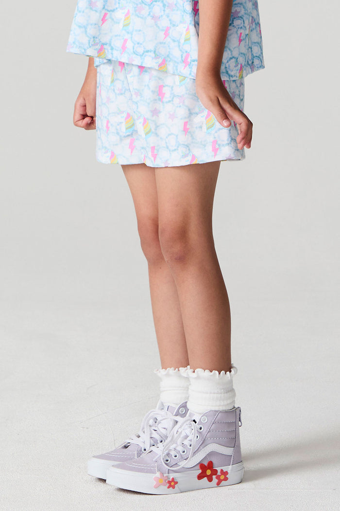 Side angle view of a girl wearing the Chaser  Unicorn Lightning Skort on a neutral background